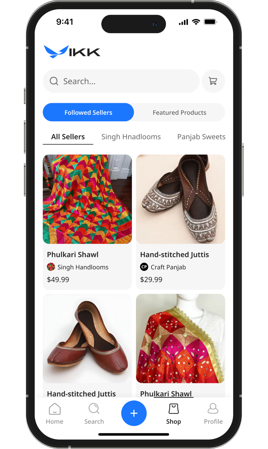 Woman in red rainbow-striped jacket and silver headphones, wearing a green star necklace, looking at the camera.